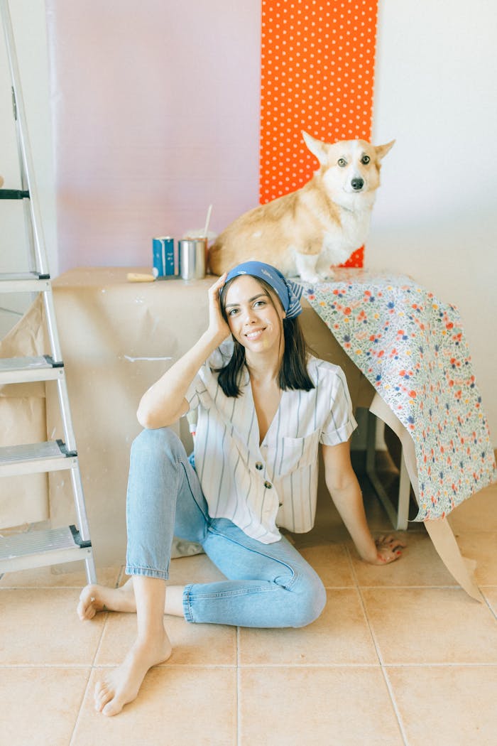 Corgi Dog near a Woman Sitting on the Ground